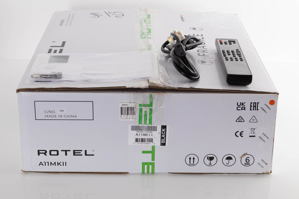 Box of a used Rotel A11MKII Integrated Amplifier with mains cable, manual, and remote