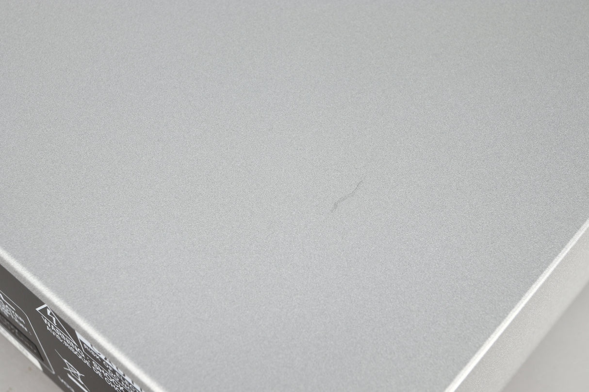 Close up of a used Rotel CD11 Tribute CD Player in a silver finish showing a scratch on top