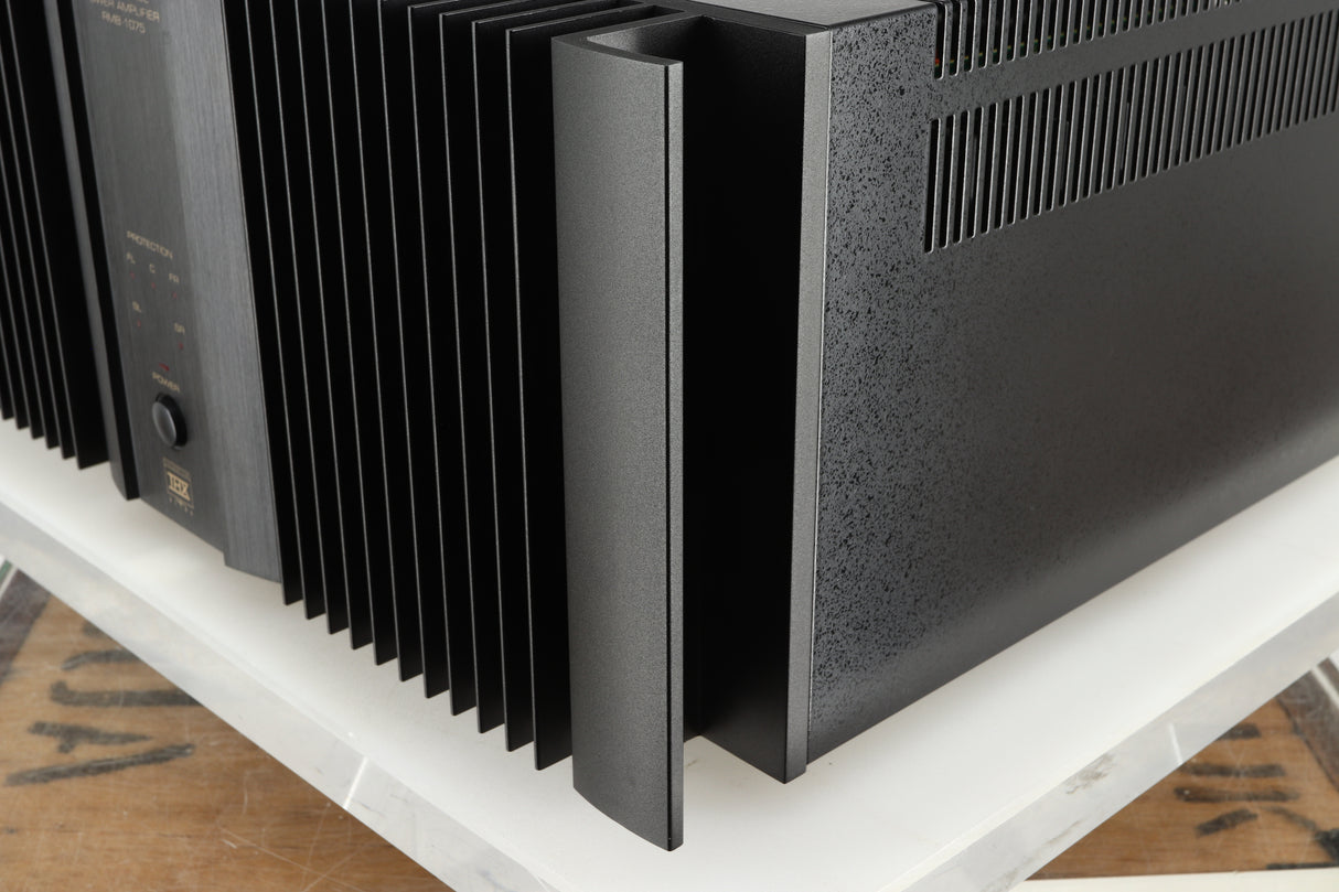 Front right corner of a used Rotel RMB1075 Power Amplifier in a black finish