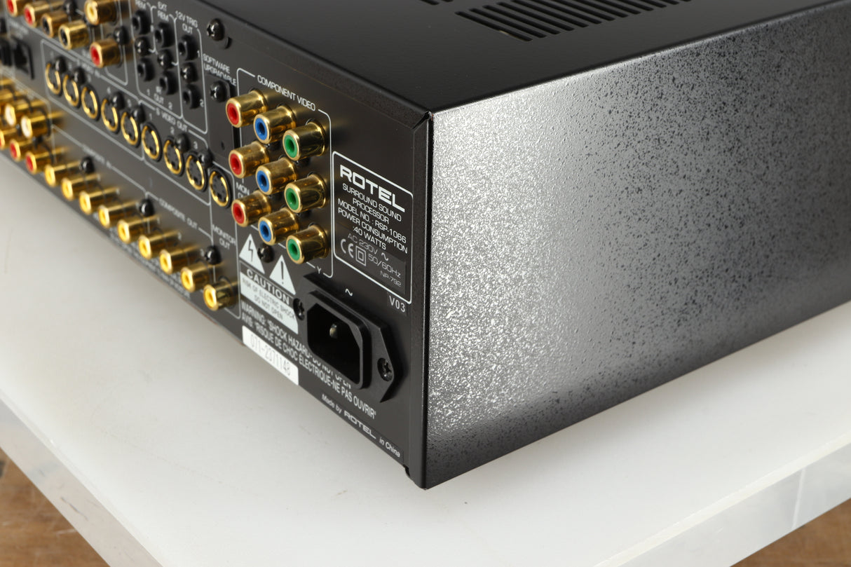 Rear left corner of a used Rotel RSP-1066 Pre Amplifier / Processor in a black finish