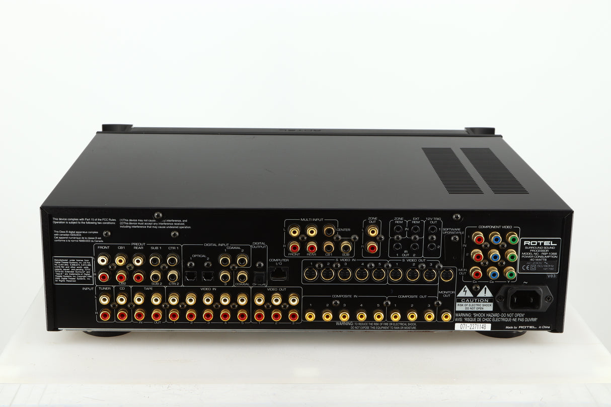 Rear view of a used Rotel RSP-1066 Pre Amplifier / Processor in a black finish showing Phono Outputs and Inputs, Optical Outputs and Mains Input