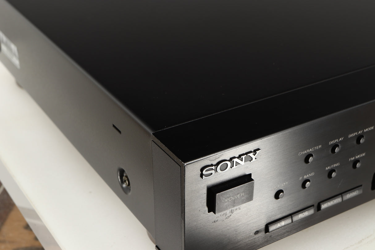 Close up of a used Sony ST-S570ES FM/AM Tuner in a black finish showing few marks on fascia