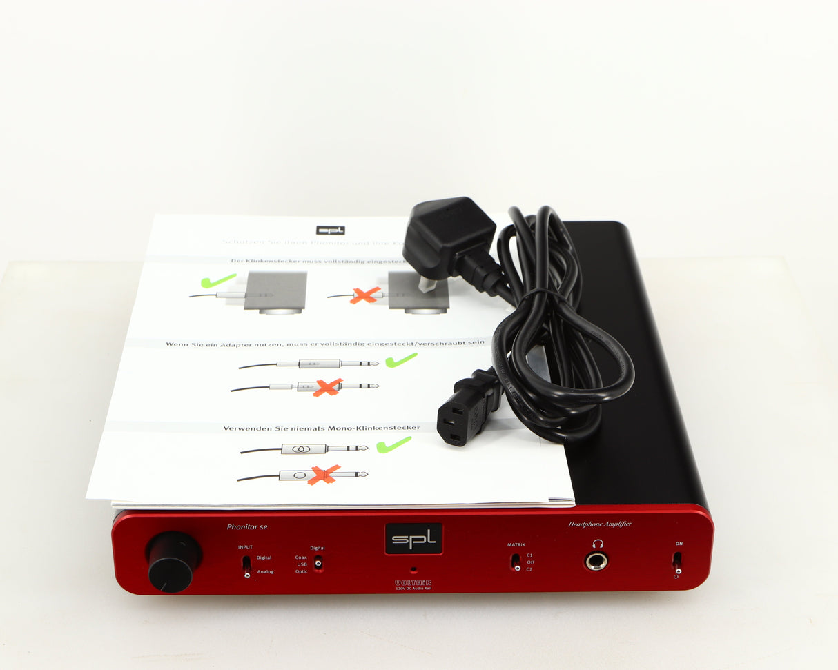 Top of a used SPL Phonitor SE Headphone Amplifier in a red finish showing Manual and Mains Cable