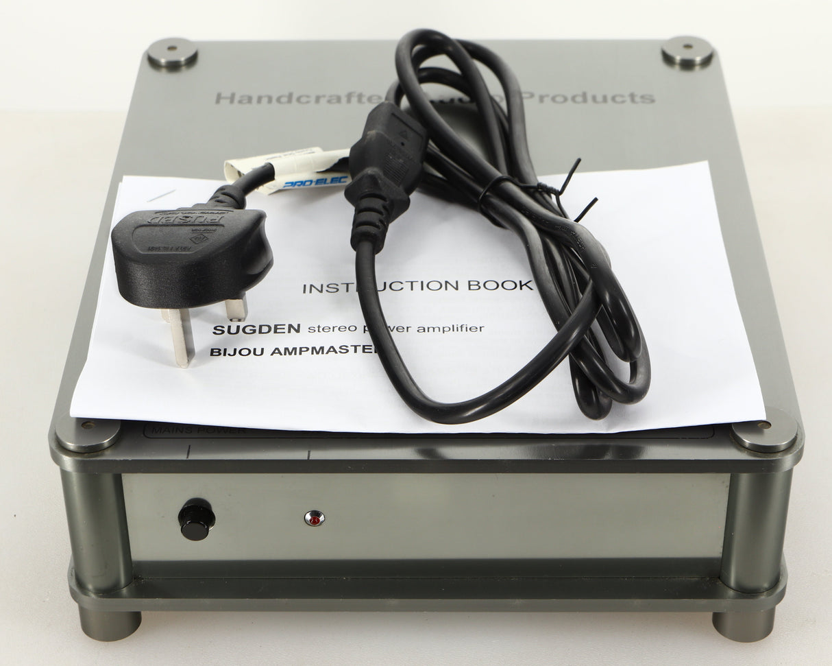 Top of a used Sugden Bijou Ampmaster Power Amplifier in a silver finish showing Manual and Mains Cable