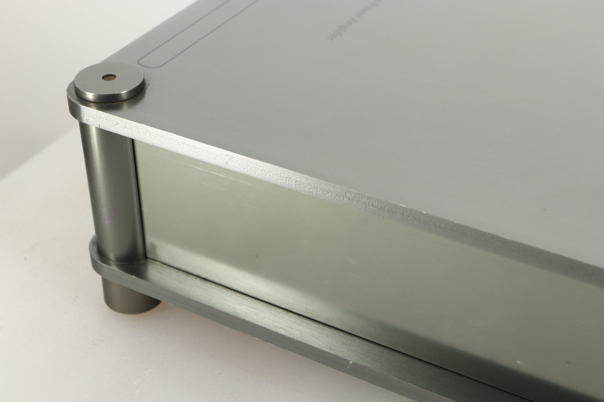 Close up of a used Sugden Bijou Ampmaster Power Amplifier in a silver finish showing scratch on right side