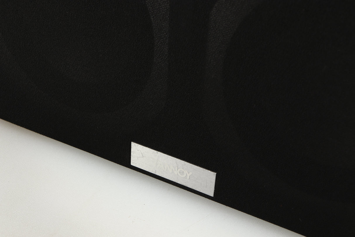 Close up of a used Tannoy Revolution DC4LCR Centre Speaker in an espresso finish showing scratching on grilles logo