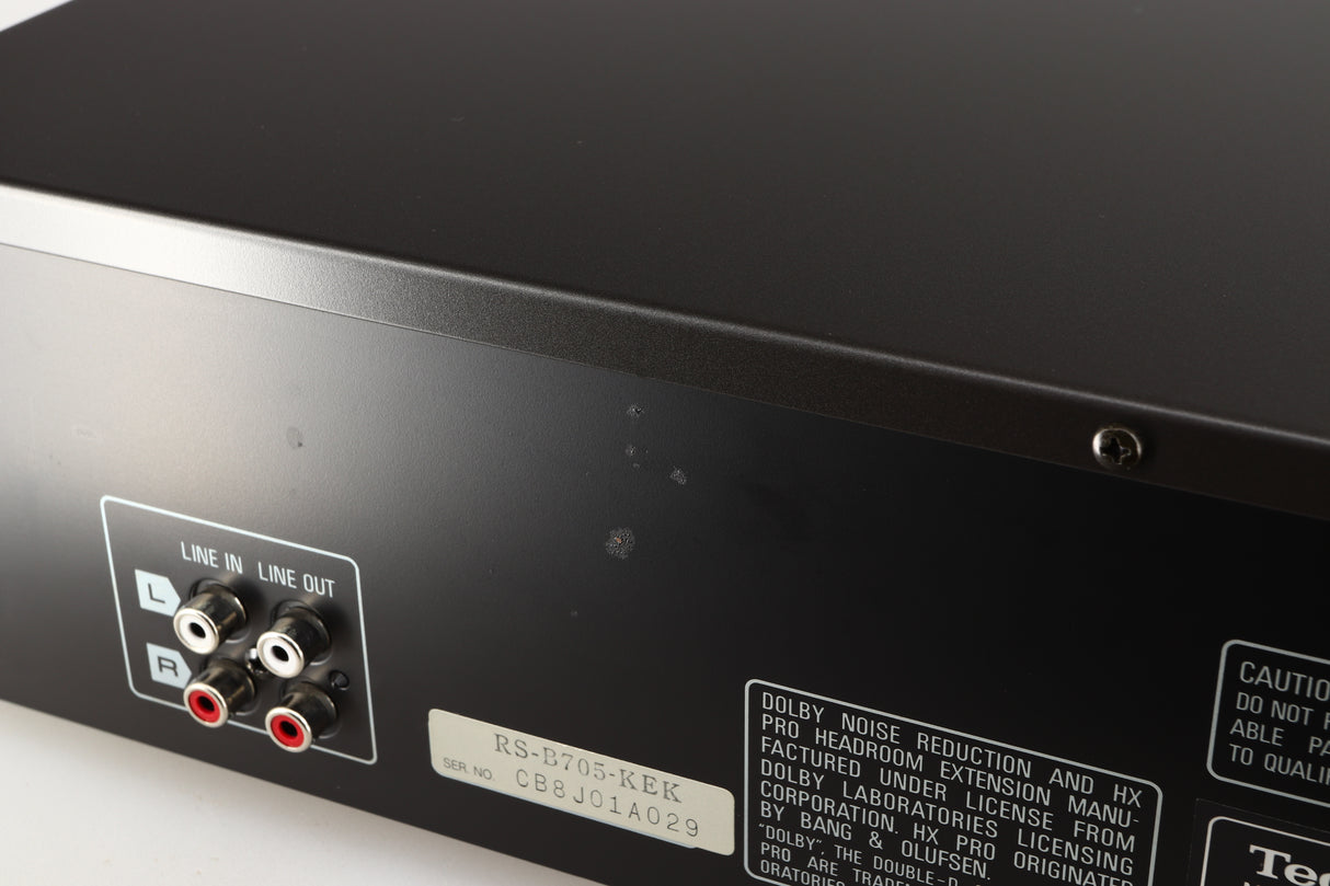 Close up of a used Technics RS-B705 Cassette Deck in a black finish showing some marks on rear