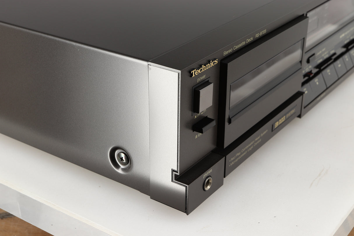 Front left corner of a used Technics RS-B705 Cassette Deck in a black finish