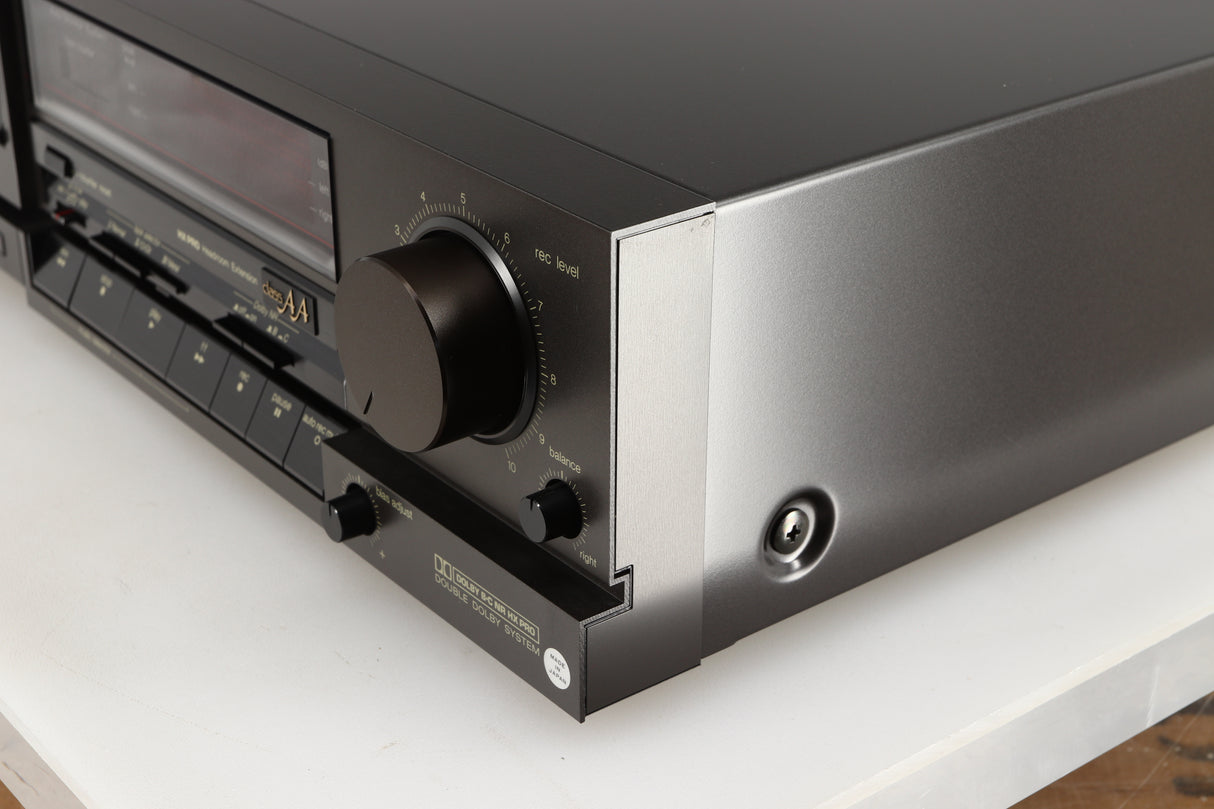 Front right corner of a used Technics RS-B705 Cassette Deck in a black finish