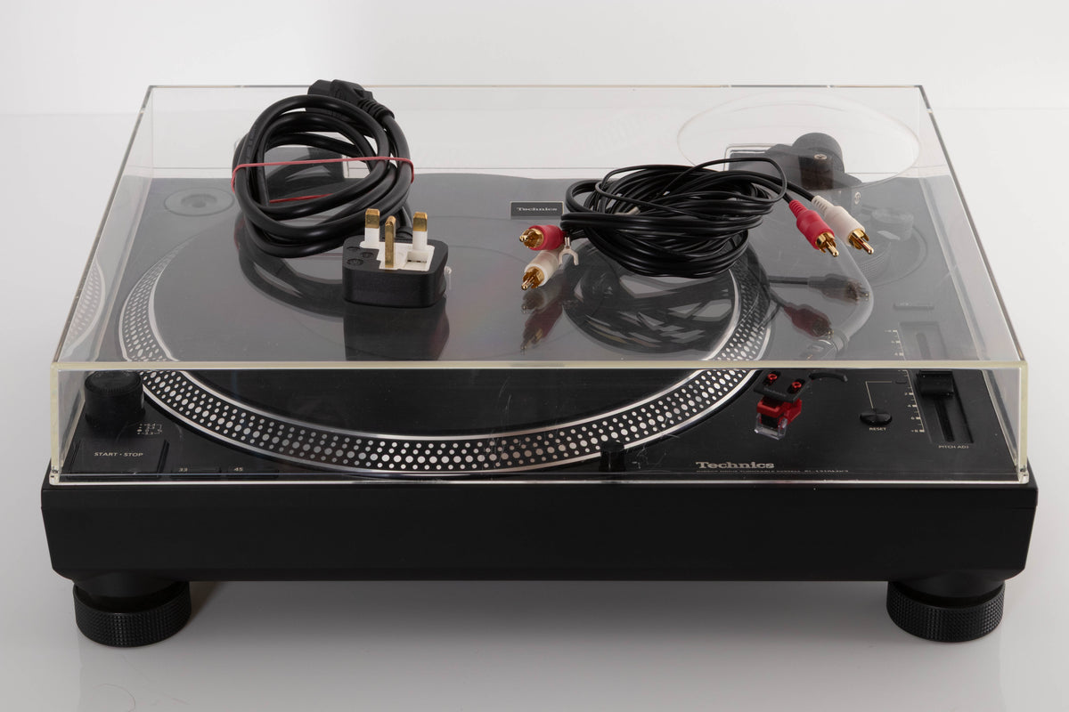 Front view of a used Technics SL-1210 MK7 Turntable with AT-40ML Cartridge with mains cable, and interconnects