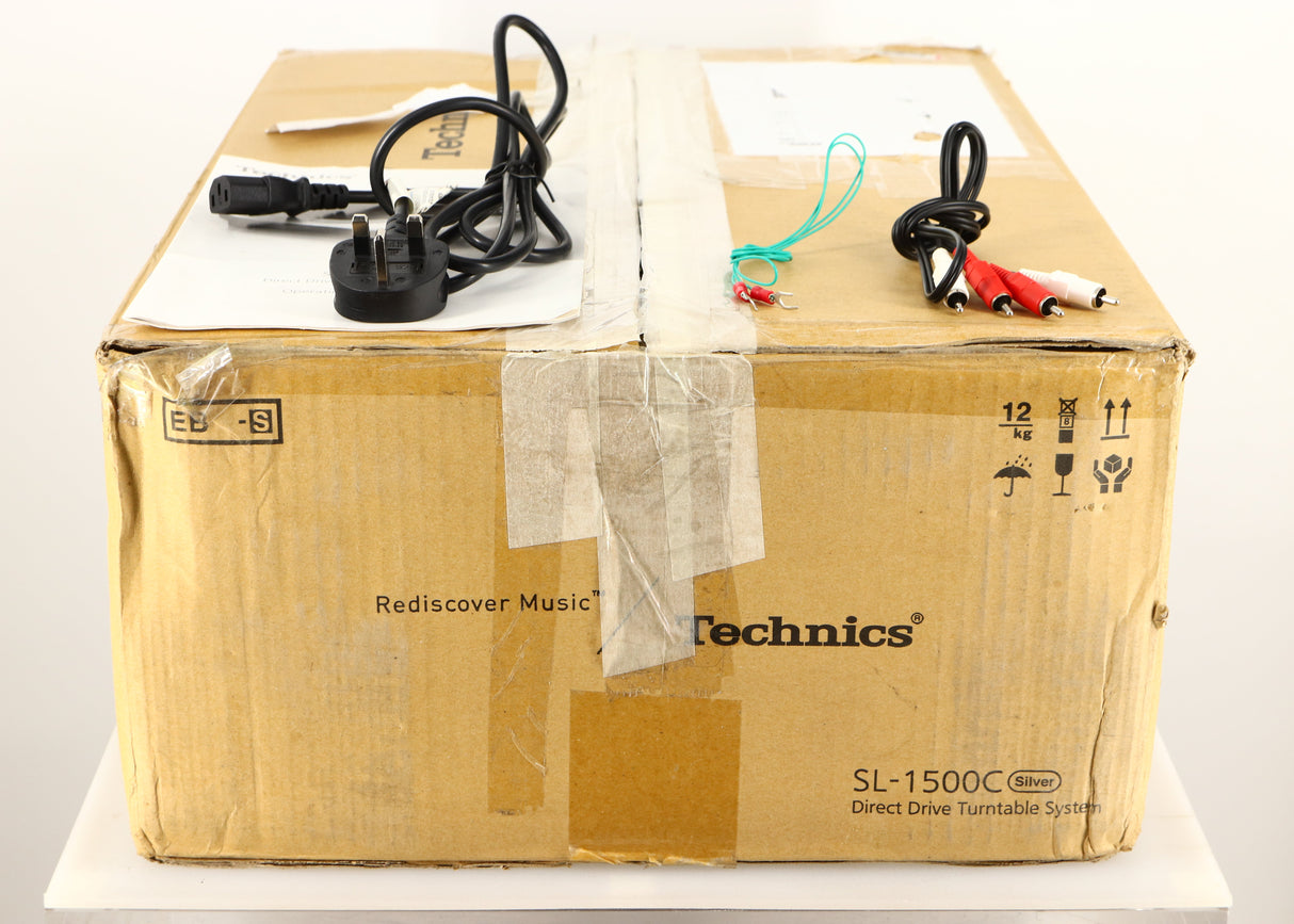 Box for a used Technics SL-1500C Turntable in a silver finish showing Manual, Mains Cable, Interconnect Cable and Spade Cable
