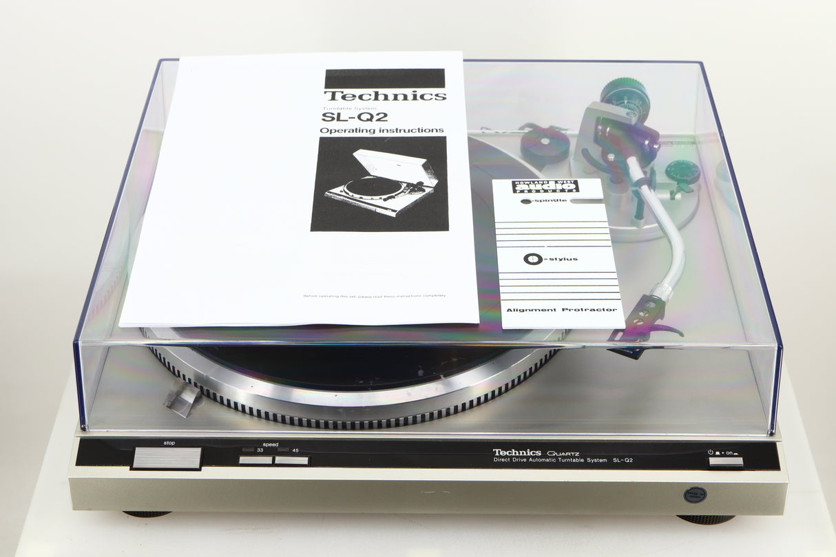 A used Technics SL-Q2 Direct Driver Turntable in Silver showing manual, and alignment protractor