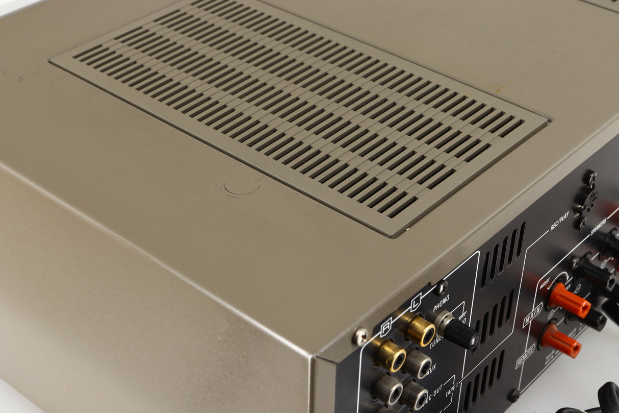 Close up of a used Technics SU-V4 Integrated Amplifier in a silver finish showing marks on top