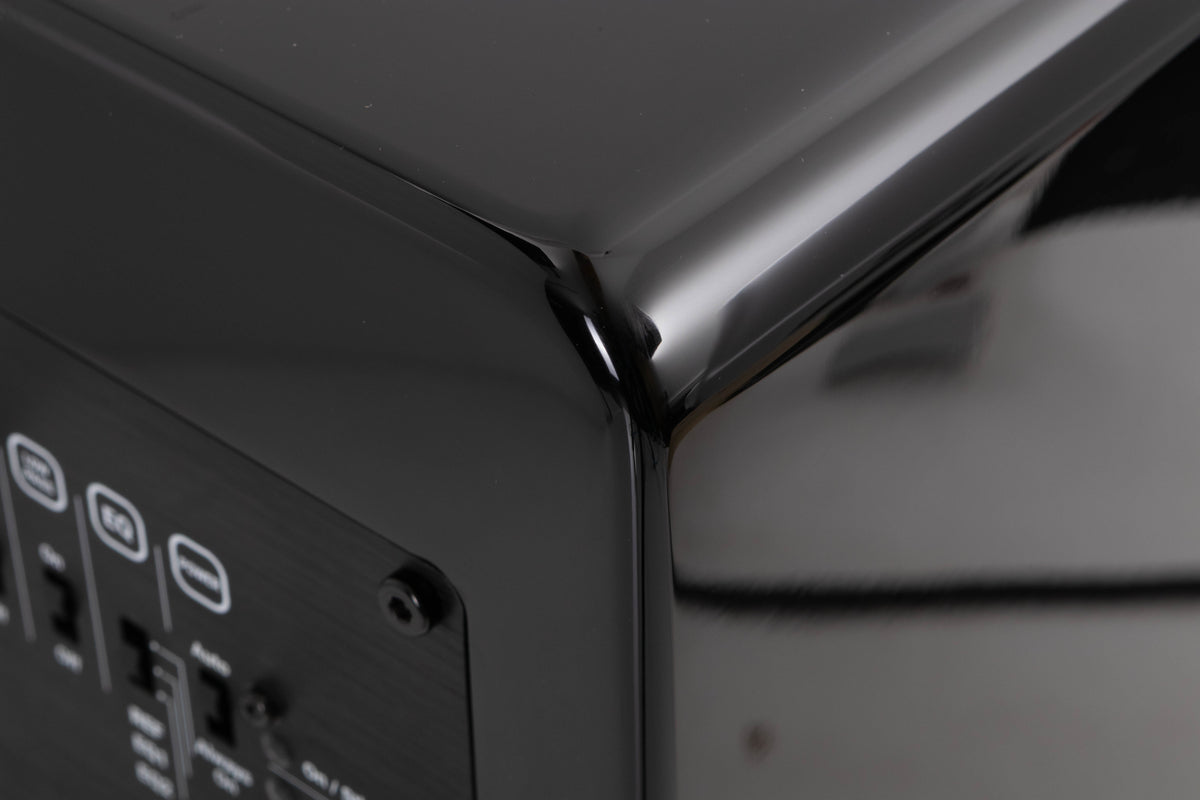 Rear left corner of a used XTZ SA-1 Subwoofer in a Gloss Black finish