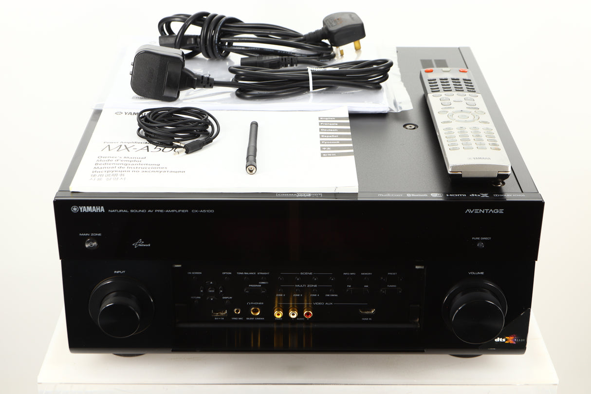 View of a used Yamaha CX-A5100 AV Pre Amplifier in Black finish with mains cables, manuals, remote, antenna, and 3.5mm cable