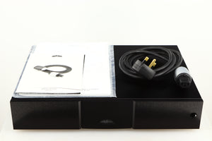 Top of a used Naim CD555PS DR Power Supply in a black finish showing Manual and Power-Line Mains Cable