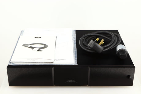 Top of a used Naim CD555PS DR Power Supply in a black finish showing Manual and Power-Line Mains Cable