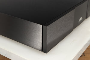 Front left corner of a used Naim CD555PS DR Power Supply in a black finish