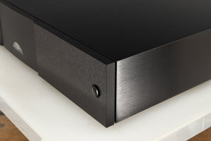 Front right corner of a used Naim CD555PS DR Power Supply in a black finish