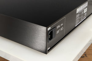 Rear right corner of a used Naim CD555PS DR Power Supply in a black finish