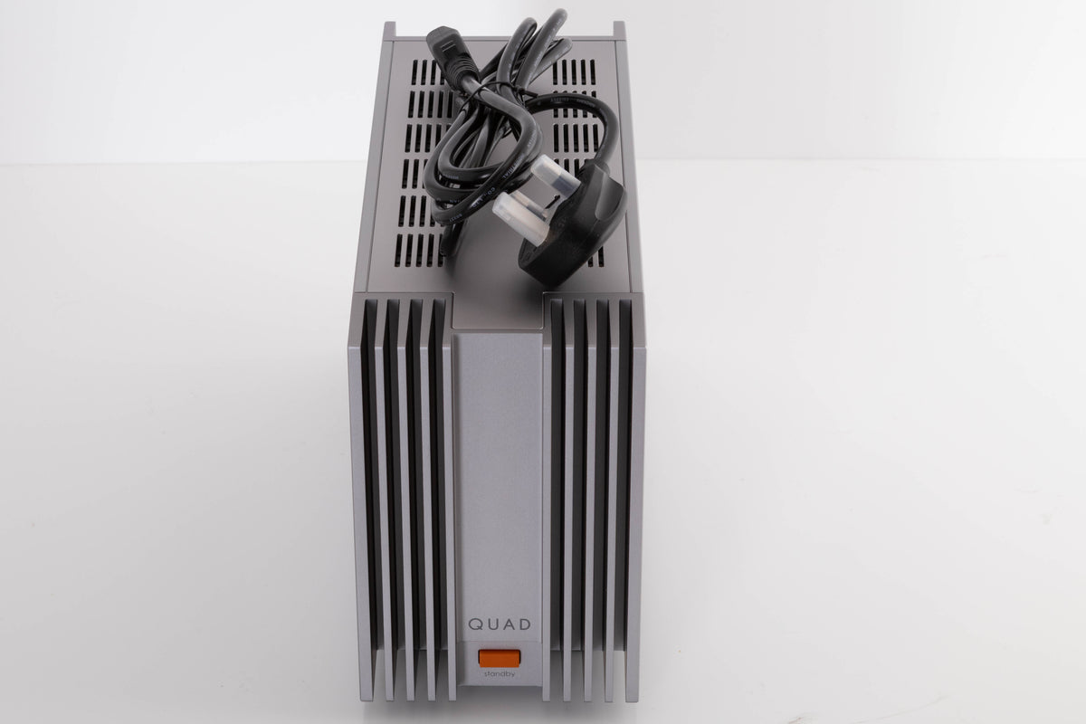 Top of a used Quad 303 Power Amplifier in a Silver finish showing Mains Cable