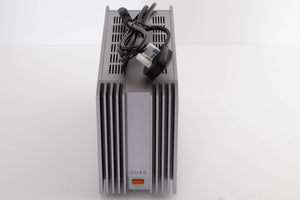 Top of a used Quad 303 Power Amplifier in a Silver finish showing Mains Cable