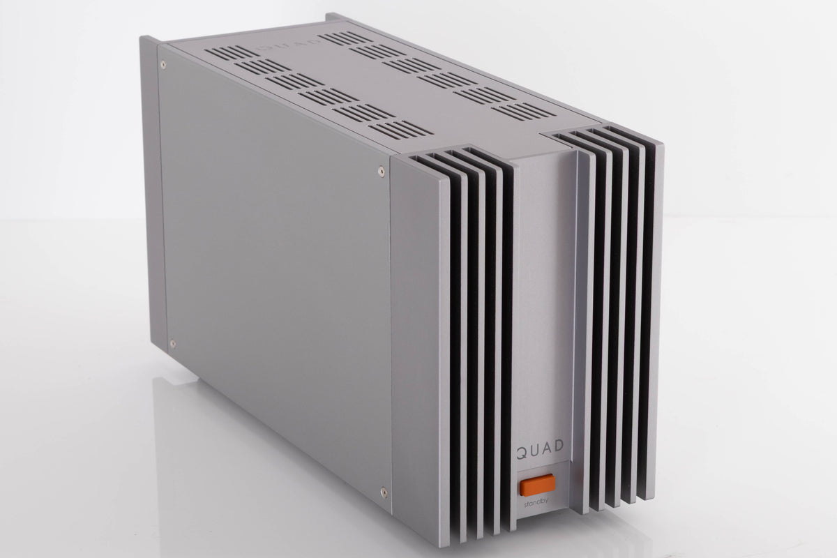 Front left corner of a used Quad 303 Power Amplifier in a Silver finish