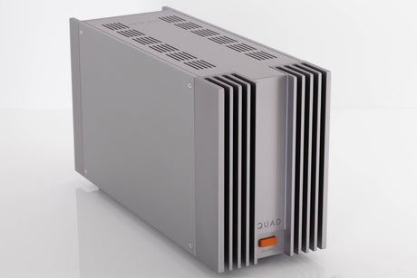 Front left corner of a used Quad 303 Power Amplifier in a Silver finish