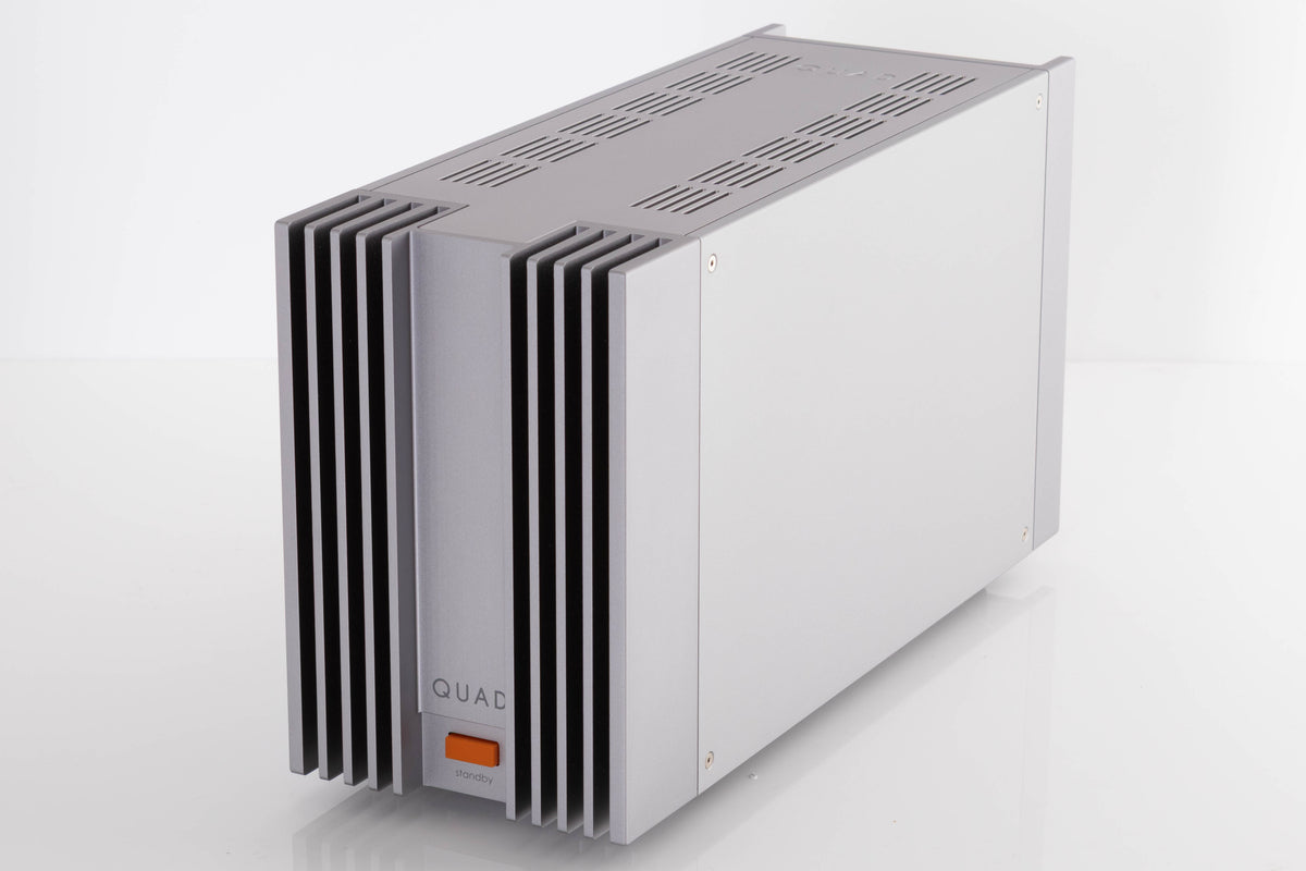 Front right corner of a used Quad 303 Power Amplifier in a Silver finish