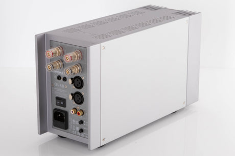 Rear left corner of a used Quad 303 Power Amplifier in a Silver finish