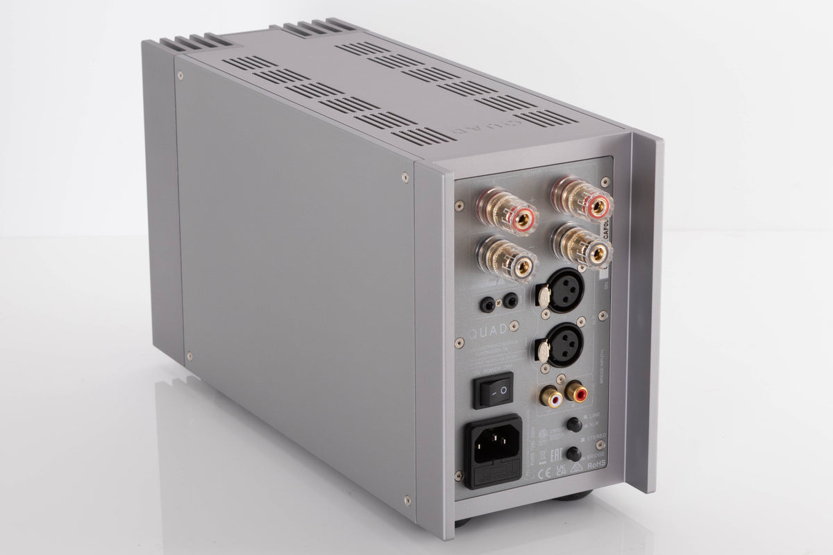 Rear right corner of a used Quad 303 Power Amplifier in a Silver finish