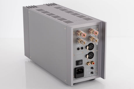 Rear right corner of a used Quad 303 Power Amplifier in a Silver finish