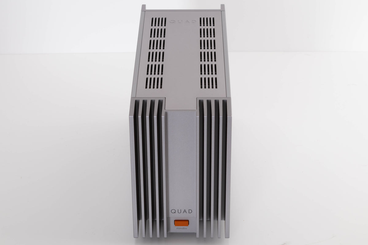 Top of a used Quad 303 Power Amplifier in a Silver finish
