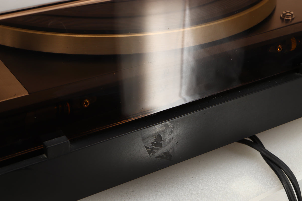 Close up of a used Dual 601 Turntable / Goldring 1042 Cartridge in a walnut finish showing mark on turntable from tape from previous owner 