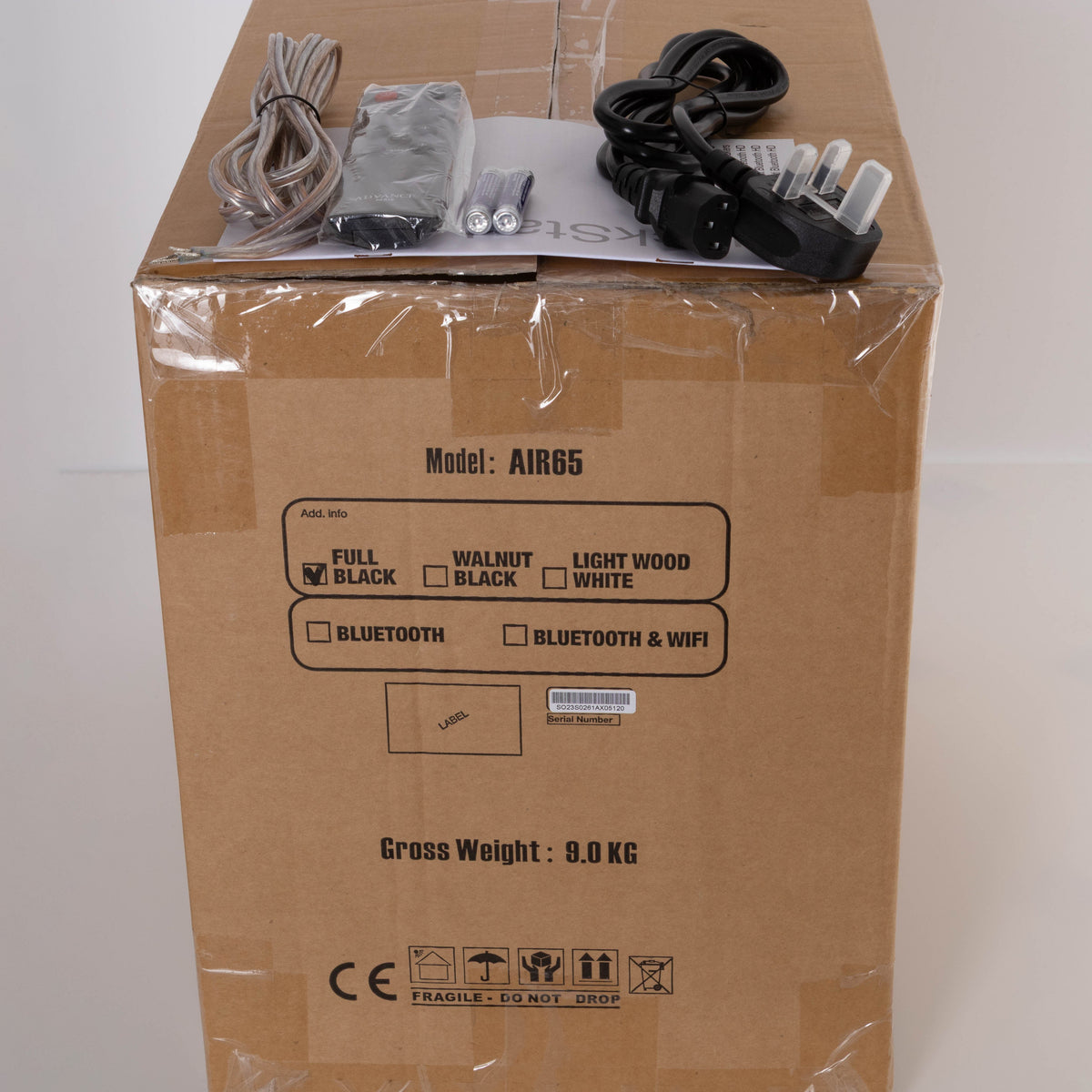 Box for a used Advanced Paris AIR 65 Wireless Speaker - Bluetooth Only in a Black finish showing Manual, Remote, Batteries and Mains Cable
