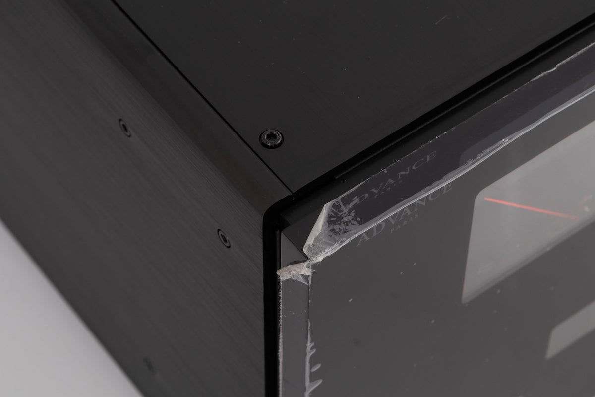 Close up of a used Advanced Paris X-i1100 Integrated Amplifier in a Black finish showing film peeling off