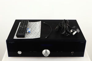 Top of a used Advanced Paris X-i75 Integrated Amplifier in a black finish showing Remote 2x Batteries, Manual and Mains Cable