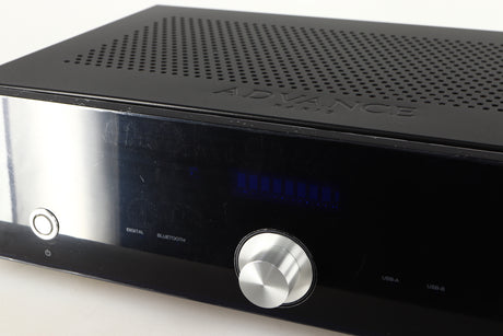 Close up of a used Advanced Paris X-i75 Integrated Amplifier in a black finish showing protective film on fascia