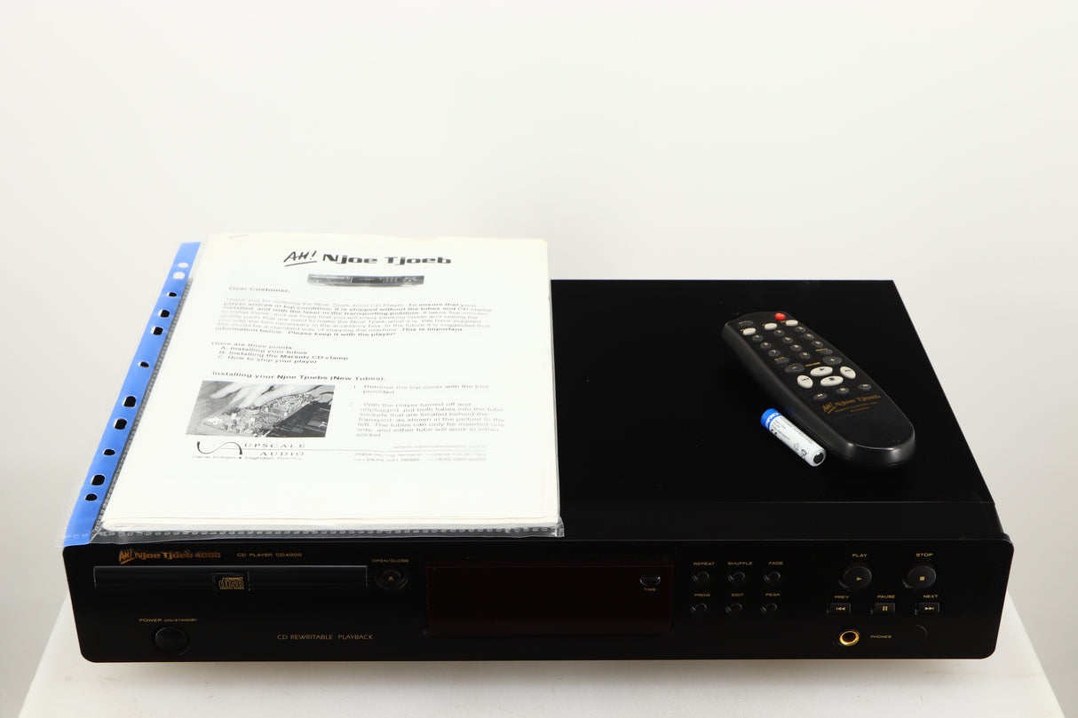 Top of a used AH! Njoe Tjoeb 4000 CD Player in a black finish showing Manual, Remote and Battery
