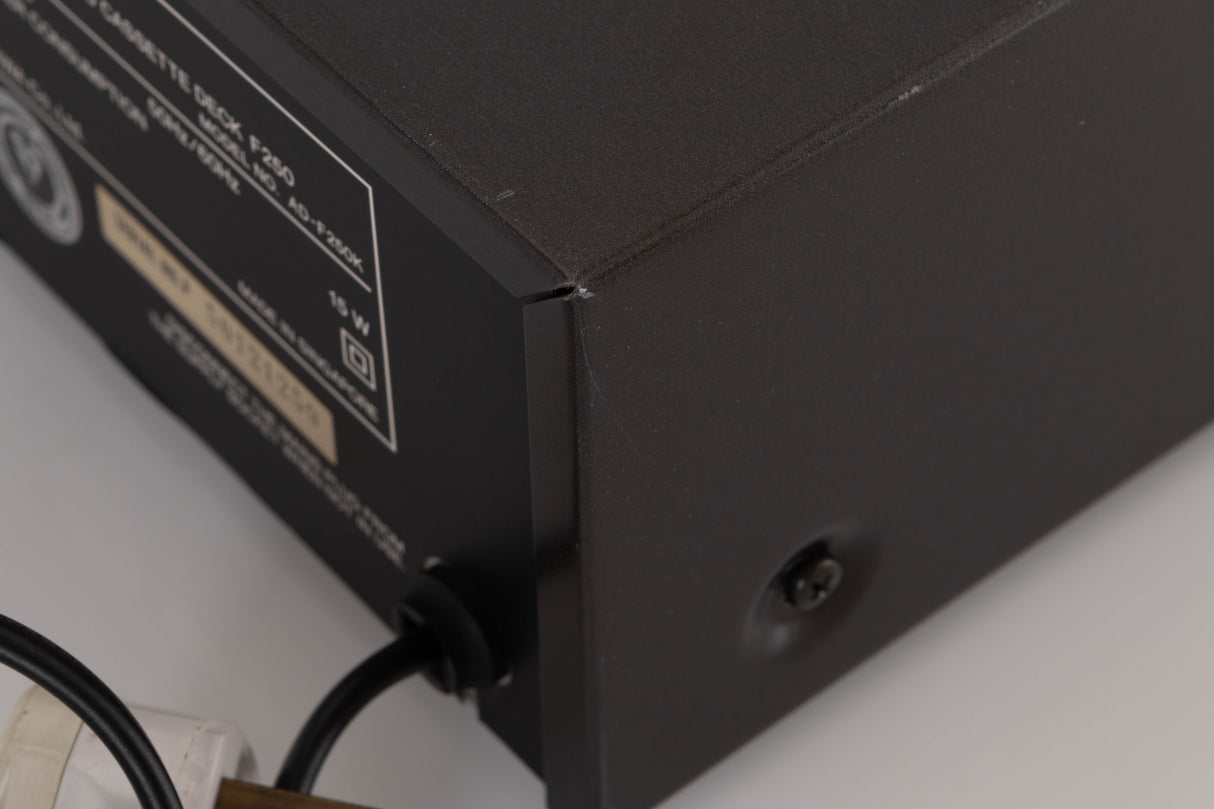 Close up of a used Aiwa F250 Cassette Deck showing scratches on unit