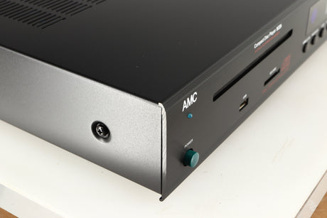 Front left corner of a used AMC XCDise-vt CD Player With MD5404us2 Tube Output in a black finish