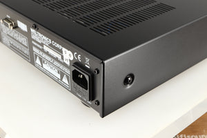 Rear left corner of a used AMC XCDise-vt CD Player With MD5404us2 Tube Output in a black finish