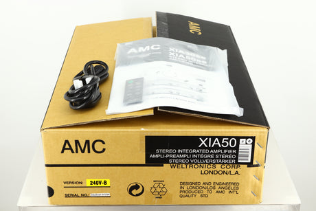 Box of an Ex Demo AMC XIA50 Integrated Amplifier showing mains cable, manual, and remote