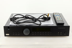 View of a used Arcam A19 Integrated Amplifier showing mains cable, and system remote 