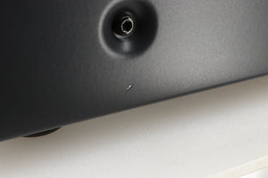 Close up view of a used Arcam A19 Integrated Amplifier in Black finish showing a small chip towards the front on the right side