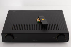 Top of a used Arcam A5 Integrated Amplifier in a Black finish showing Remote and Batteries