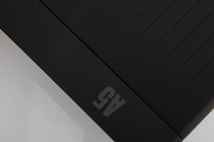 Close up of a used Arcam A5 Integrated Amplifier in a black finish showing light scratch on top