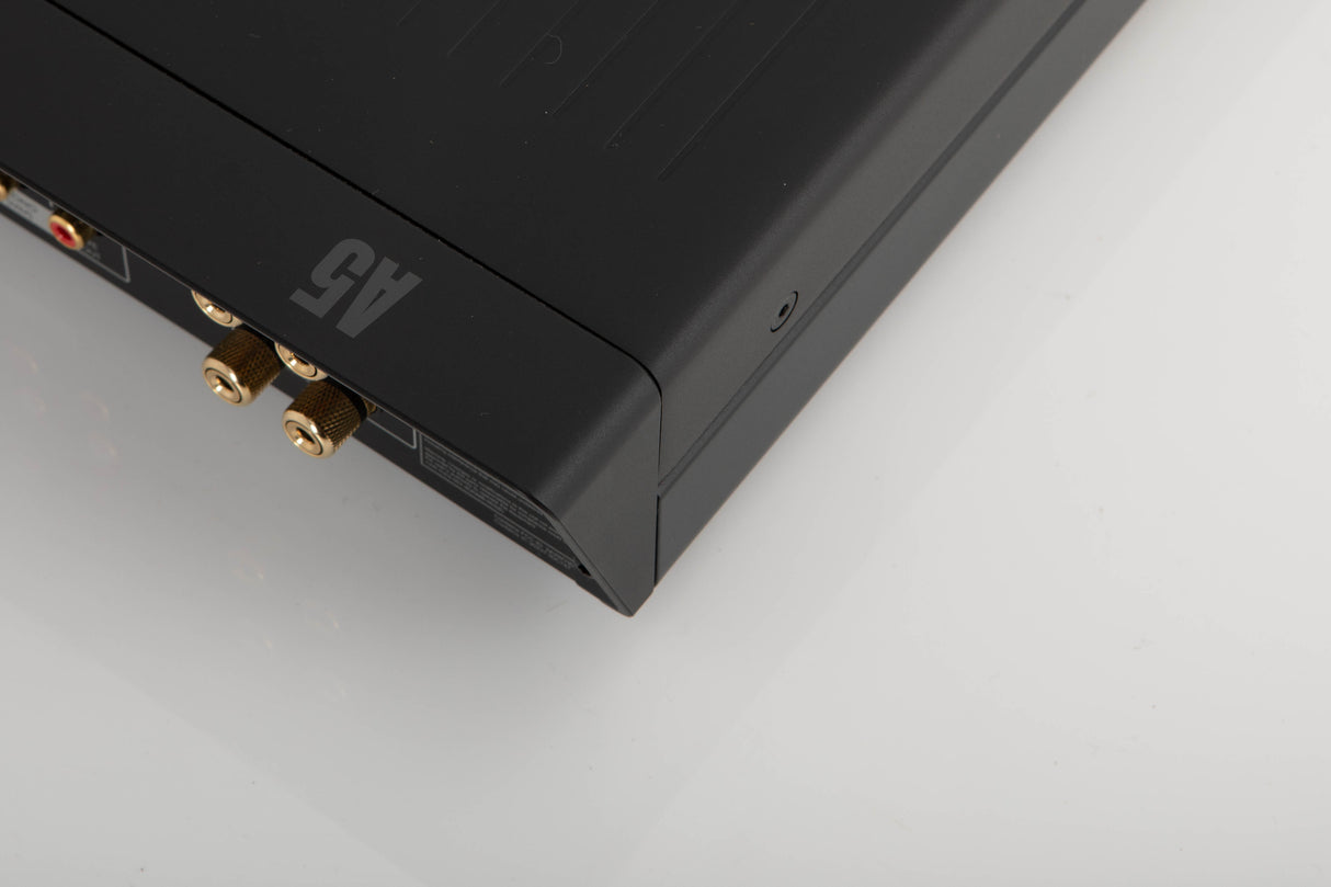 Rear left corner of a used Arcam A5 Integrated Amplifier in a black finish