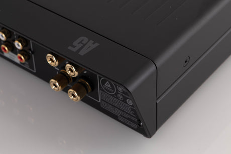 Rear left corner of a used Arcam A5 Integrated Amplifier in a Black finish