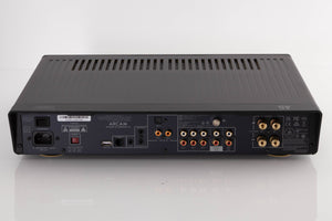 Rear view of a used Arcam A5 Integrated Amplifier in a Black finish showing Mains Input, USB Input, Digital Inputs, Optical Input, Network Input, Analogue Inputs, Phono Inputs and Pre Outputs